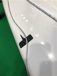 Simple device to prevent the spinnaker sheet going overboard and dragging in the water